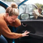Female Motorist In Crash For Crash Insurance Fraud Getting Out Of Car